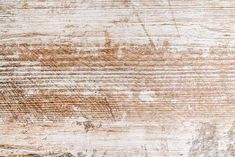 an old wooden surface with peeling paint and chipped wood grains, as a background or texture