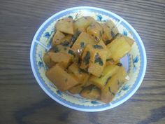 a bowl filled with food on top of a wooden table