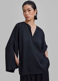 Color: Black Lightweight fluid fabric Relaxed fit V neckline Split dolman sleeves Slip on style Unlined 100% Acetate Machine Wash Cold By Malene Birger. Imported Elegant Silk V-neck Tunic, Silk Top With Draped Sleeves For Work, Silk Tops With Draped Sleeves For Work, Silk V-neck Top With Blouson Sleeves, Chic V-neck Tunic For Workwear, Elegant Oversized V-neck Top, Evening V-neck Top With Blouson Sleeves, Chic Blouse With Kimono Sleeves For Work, Chic Workwear Blouse With Kimono Sleeves