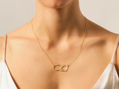 Celebrate eternal love and connection with our Infinity Name Necklace. This exquisite piece beautifully combines a timeless symbol with the personal touch of your names, creating a unique and heartfelt accessory. The pendant features the infinity symbol, elegantly intertwined with your chosen names or words, creating a meaningful and romantic design. • Material: 14k Solid Gold (Stamped 14K for authenticity) • Color Options: Yellow, Rose, White • Chain Style: Cable Chain • Chain Width: 1.10 mm • Elegant Initials Name Necklace For Anniversary, Elegant Engraved Name Necklace For Anniversary Gift, Infinity Name Necklace For Anniversary, Gold Infinity Necklace With Engraving, Elegant Infinity Name Necklace For Anniversary, Gold Infinity Necklace Engraved, Gold Engraved Infinity Necklace, Elegant 14k Gold Infinity Jewelry, Elegant 14k Gold Infinity Necklace