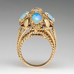 This beautiful vintage ring features an openwork design and is centered with one (1) old mine cut diamond set into a six-prong setting. The center stone is bordered with four (4), prong set, oval cabochon cut natural crystal opals. The ring measures 19.9mm at the top, rises 16.4mm above the finger, tapering to 5.1mm wide and 1.3mm thick at the base of the shank. It is currently a size 8.5. Two of the opals are chipped but it does not distract from the beauty of this piece. Antique Oval Three Stone Diamond Ring, Oval Opal Ring With Rose Cut Diamonds, Antique Oval Three Stone Rings, Classic Three-stone Opal Ring For Wedding, Oval Three Stone Opal Ring Fine Jewelry, Vintage Diamond Opal Ring For Anniversary, Vintage Multi-stone Oval Cabochon Rings, Vintage Oval Three Stone Ring, Vintage Oval Three-stone Ring