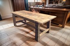 a wooden table sitting on top of a hard wood floor