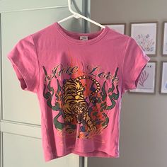 -Never Worn -Perfect Condition -Size L Open To Offers! Trendy Urban Outfitters Relaxed Fit T-shirt, Y2k Pink Printed Tops, Retro Pink Top With Text Print, Pink Y2k Printed Tops, Y2k Pink Graphic Print Top, Pink Y2k Style Printed Tops, Urban Outfitters Text Print Tops For Streetwear, Pink Printed Y2k Tops, Trendy Cotton T-shirt By Urban Outfitters