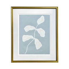 a white and gold framed print with a leaf on the left hand side, against a light blue background