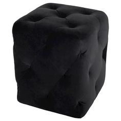 a black square footstool sitting on top of a white floor