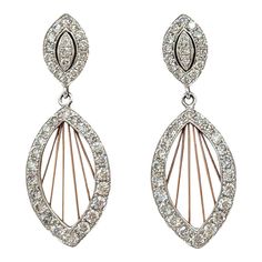 Beautiful dangle dream catcher design earrings with 1.18 ct. good quality white diamond rounds.  Handmade in 14k white and rose gold.  Metal: Gold Stone: White Diamond Stone Cut: Round Cut  Dimensions for the item are unknown. Please reach out in the seller Q&A with questions Design Earrings, Rose Gold Metal, Stone Cuts, Diamond Stone, White Diamond, Good Quality, Dream Catcher, Jewelry Earrings Dangle, Dangle Drop Earrings