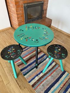 two small tables sitting in front of a fire place