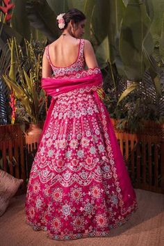 Magenta pink lehenga with mirror work, thread embroidery and foil motifs. Comes with blouse and dupatta.
Component: 3
Pattern: Embroidery
Type Of Work: Mirror, Thread, Gota Patti and Foil
Neckline: Sweetheart
Sleeve Type: Sleeveless
Fabric: Organza
Color: Pink
Other Details: 
Scallop detail on the neckline and hem
Dupatta with scallop and cutwork border
Note: Blue lehenga set worn by the other model is not for sale
Occasion: Bride - Aza Fashions Aneesh Agarwaal, Scalloped Dupatta, Embroidery Mirror, Organza Embroidery, Indian Designs, Floral Lehenga, Organza Lehenga, Blue Lehenga, Pink Lehenga