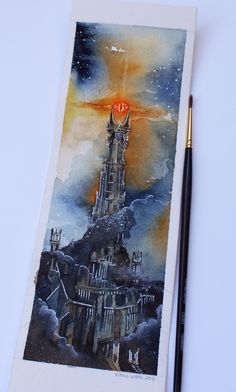 a drawing of a castle on top of a hill next to a pen and paper