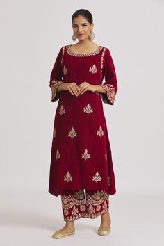 Red velvet kurta with floral hand, machine embroidery. Paired with pyjama.
Components: 2
Pattern: Embroidered
Type Of Work: Floral
Neckline: Round
Sleeve Type: Three quarter
Fabric: Velvet
Color: Red
Other Details: 
Cutwork border sleeve detailing
Model height: 5ft 11inches, wearing size M
Occasion: Wedding - Aza Fashions Velvet Kurta, Straight Kurta, Velvet Color, Pajama Set Women, Pyjama Set, Cut Work, Sleeve Detail, Set For Women, Aza Fashion