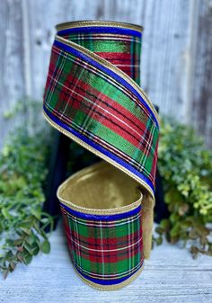 three different colored plaid ribbon on top of each other in front of a wooden fence