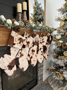 christmas stockings hanging from a mantel in front of a fireplace