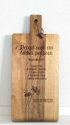 a wooden cutting board with writing on it