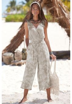 Step into the world of fashion with this jumpsuit, a trendy choice for every woman. Chic V-neck Jumpsuits And Rompers For Beach Season, Trendy Beach Overall Jumpsuits And Rompers, Trendy Beach Overalls And Rompers, Elegant Overall Jumpsuits And Rompers For Vacation, Elegant Vacation Jumpsuits And Rompers In Overall Shape, Elegant Vacation Overalls And Rompers, Chic V-neck Jumpsuits For Beach Season, Elegant Jumpsuits And Rompers For Vacation, Overall Jumpsuits And Rompers For Beach Day Out