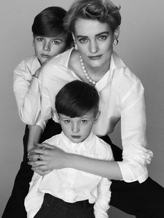 two women and a boy are posing for a black and white photo