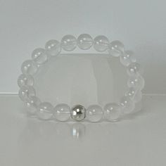 "This bracelet is a beautiful addition to your collection, not only because of its elegance and radiance, but also because these natural gemstones work to amplify the energy of any other crystal bracelet you pair it with. Clear quartz is often referred to as the \"master healer\" because of its ability to amplify and perfect energy. It amplifies the power of other crystals. Promotes clarity of thought, balance, and protection. Clear quartz is a cleansing stone that can help clear away negative energy and promote harmony. Below are 5 words to help you remember the main properties of this crystal: 1.Energy Amplifier 2.Cleansing 3.Balance 4.Healer 5.Clarity" Elegant Crystal Bracelet For Meditation, Elegant Hand-strung Crystal Bracelet For Meditation, Elegant Hand-strung Crystal Bracelet For Healing, Elegant Hypoallergenic Crystal Bracelet For Healing, Elegant Crystal Gemstone Bracelet For Meditation, Elegant Crystal Bracelet With Clear Round Beads, Elegant Adjustable Gemstone Beads Crystals, Elegant Moonstone Crystal Bracelet With Gemstone Beads, Elegant 8mm Beads Crystal Bracelet For Meditation