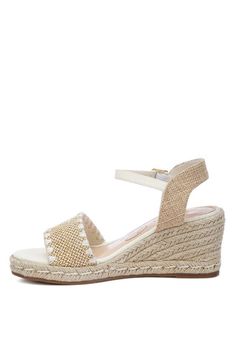 Groove your way through summer festivals or lounge by the pool with a cocktail in hand - all while rocking our fabulous raffia espadrilles! With a classic wedge heel giving a nod to tradition and the playful addition of raffia for a modern twist, these shoes are an absolute essential for spicing up any closet.Type: EspadrillesUpper Material: RaffiaLight Cushion InsolesOuter Sole: TPRAnkle Strap DetailPin Buckle FasteningWedge HeelOpen Round ToeLight Cushion InsoleSH4567Material Composition: Raff Round Toe Wedge Sandals For Beach, Beach Season Synthetic Heels, Beige Round Toe Heels For Summer, Closed Toe Synthetic Sandals For Summer, Closed Toe Synthetic Summer Sandals, Straw Wedge Sandals With Ankle Strap And Cushioned Footbed, Synthetic Round Toe Sandals For Summer, Straw Wedge Sandals With Cushioned Footbed And Ankle Strap, Synthetic Closed Toe Summer Sandals