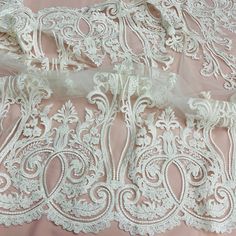 Let the beauty of your special occasion take center stage with our exquisite Beaded & Corded Bridal Lace Fabric Embroidered on 100% Polyester Net Mesh. Featuring the finest beaded and corded French Lace, this exquisite fabric is perfect for crafting elegant wedding dresses, evening gowns, quinceanera dresses, dance costumes and more. This high quality fabric is adorned with embroidery, beads, pearls and sequins and is available in five colors. Our luxurious beaded couture lace, beaded bridal lac Elegant Embroidered White Lace, White Embroidered Fabric With Lace Trim For Ceremonies, Elegant White Lace With Intricate Embroidery, Elegant White Lace With Floral Embroidery, Elegant Cream Lace Embroidered Fabric, Cream Embroidered Lace For Ceremony, Elegant Cream Embroidered Lace Fabric, Elegant Wedding Embroidered Fabric With Lace Trim, Ceremony Embroidered Cream Lace