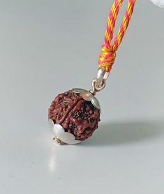 Sterling silver Rudraksha necklace . lord Shiva pendant necklace. This beaded necklace can be worn by men, women, girls, boys,  Beads size 19×21mm approximately Beads material :-Rudraksha Item weight :-5.740 gm  colorful cotton soft string :- 1 Necklace length :- 15"- 30" inches adjustable   925 sterling silver cap necklace  Rudraksha Acts as a protective shield for the body Radiates special energy that has a positive effect on the body, mind, and soul Mitigates negative karma Improves concentration Balances the chakras and removes potential illnesses As the jewelry is made by hand, each item is unique and may vary slightly in size and color to those photographed here. *Buyer note-The buyer is fully responsible for any charges, import, caution, duties and taxes in buyer country. Silver Rudraksha Mala, Adjustable Silver Mala For Meditation, Silver Beads Temple Necklace Gift, Sterling Silver Amulet Necklace For Puja, Sterling Silver Amulet Necklaces For Puja, Silver Adjustable Spiritual Mala, Adjustable Silver Spiritual Mala, Silver Amulet Necklaces For Puja, Silver Spiritual Mala For Meditation