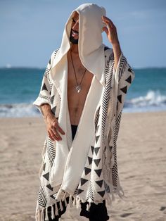 Mens Handwoven and Hand-block printed Poncho in Black and White, Wonderful Cape for a Festival Outfit. Great as a cover up, warm and soft, this poncho will be a great addition to your next desert or a rainforest adventure! The source of material was limited, and only few pieces were made from this fabric. This beautiful textured cotton has a nice and soft touch. Black and white hand-block print resembles the tribal print of the African mud cloth.  The fabric was hand printed by the local artisan Nomad Aesthetic Fashion, Spiritual Fashion Men, White Cotton Outerwear For The Beach, White Cotton Beach Outerwear, White Winter Vacation Outerwear, Cotton Outerwear For Winter Vacation, Cotton Winter Outerwear For Vacation, Winter Cotton Outerwear For Vacation, Desert Clothing