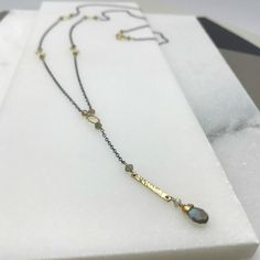 "This delicate Labradorite necklace is certain to catch everyone's eye. Delicate Labradorite beads and minimalist gold rings are interspersed on an airy gold chain. The subtle \"Y\" drop falls to the perfect point for your décolletage. Just so the back of your neck is not forgotten, we have added the lightest splash of color with two small beads finishing the closing clasp. Just the right touch for putting your hair up for a night of dancing. Total Length: 36 1/2\" Materials: Stones: Labradorite Minimalist Lariat Necklace With Satellite Chain, Handmade Minimalist Long Lariat Necklace, Handmade Minimalist Lariat Necklace, Minimalist Handmade Long Lariat Necklace, Lariat Necklaces With Satellite Chain For Gifts, Minimalist Brass Necklace With Gemstone, Elegant Labradorite Necklace With Adjustable Chain, Minimalist Brass Gemstone Necklace, Dainty Handmade Lariat Necklace With Dangle