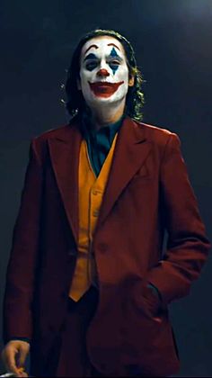 a man in a red suit and clown mask