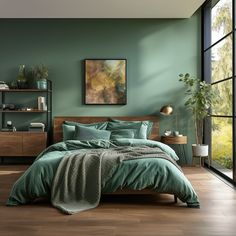 a bedroom with green walls and wood flooring has a large bed in the middle