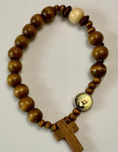 hand beaded with 4-7mm natural brown and natural wooden beads and wooden cross and Padre Pio color image, with double elastic cord. It's about 7-8 inches long Color might be slightly different, cause of lighting effect Rosary Gift, Catholic Bracelet, Rosary Bracelet, Wooden Cross, Natural Brown, Colour Images, Hand Beading, Rosary, Wooden Beads