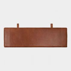 the back side of a brown leather case on a white background with clippings