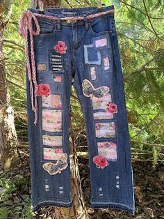 These pre-loved jeans started life as pair from Jeans West size 11, NZ sizing. They are now a funky-boho-hippy designer pair created by me. Adorned with fabrics, lace, buttons and braids, featuring patches, butterflies and florals in pinks.  Machine and hand sewn and have been washed after embellishing. Braided wool/cotton belt included. Please check my other listings for more up-cycled jeans. MEASUREMENTS Waist 31-32 in (79-81cm)  2 buttons for adjusting. Hips (widest part) 40 in (101.5cm) Inside leg 29 in (74cm) Outside leg 38.5in (98cm) Please measure carefully. Pink Distressed Bottoms For Fall, Fall Distressed Pink Bottoms, Bohemian Straight Leg Jeans For Summer, Bohemian Straight Leg Summer Jeans, Summer Festival Jeans With Patchwork, Summer Festival Patchwork Jeans, Spring Festival Denim Jeans, Bohemian Jeans For Summer Festivals, Bohemian Summer Festival Jeans