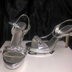 Never Worn Before Silver Shiny Heels For Formal Occasions, Elegant Shiny Silver Heels, Formal Silver Shiny Heels, Silver Heels With Round Toe In Synthetic Material, Silver Synthetic Heels With Round Toe, Silver Open Toe Heels For Formal Occasions, Silver Open Toe Heels For Night Out, Silver Shiny Heels For Spring, Metallic Silver Heels For Spring