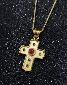 Βyzantine Handmade Gold Cross with Natural Ruby and Sapphire. An exquisite handmade Byzantine cross in 14 yellow gold and set with a central ruby of 0.29 carats and diameter 3,70mm and 5 sapphires diameter 1.35mm ideal choice for a baptismal cross but also as a special and unique piece of jewelry that you can wear every day. Details: Height32 mm Width:20 mm Weight:5.20gr Metal:14k Yellow Gold  Style:      Baptism Cross ❣️ For more  crosses take a look here      👉  https://www.etsy.com/shop/Gior Necklace With Red Stone, Byzantine Cross, Byzantine Jewelry, Ruby And Sapphire, Cross Gold, Historical Jewellery, Handmade Gold, Gold Cross, Red Stone