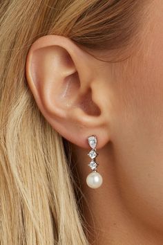 Indulge in timeless elegance with these crystal stud earrings with a delicate pearl drop on the end. Their subtle yet stunning design makes them a must-have accessory for any bride. Elegant Cubic Zirconia Jewelry For Mother Of The Bride, Timeless Evening Bridal Earrings With Cubic Zirconia, Classic Bridal Earrings With Sparkling Stones, Classic Wedding Crystal Earrings With Cubic Zirconia, Pearl-embellished Cubic Zirconia Drop Earrings, Refined Elegant Jewelry For Wedding, Exquisite Pearl Drop Bridal Earrings For Evening, Exquisite Evening Bridal Earrings With Pearl Drop, Elegant Pearl Earrings With Cubic Zirconia