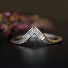 "This simple and gorgeous art deco V ring is crafted in 14k gold with 1 princess cut diamond at the tip and baguette diamonds forming the V. The diamonds are securely held in a clean channel setting. This wedding ring will be a snug fit for any engagement ring! * Diamond Wt. : 0.08 Cts (Baguette) + 0.03 ct (Princess) * Color-Clarity Grade : G-H, Vs-Si * Gold - 14kt, solid white gold (other options available) If you like this ring, please press \"Pin it\" button on the right of your screen. Find Art Deco Platinum Jewelry With Baguette Diamonds, Wedding 14k White Gold Diamond Ring With Baguettes, 14k White Gold Wedding Ring With Baguette Diamonds, 14k White Gold Baguette Diamond Wedding Ring, Wedding Jewelry With Baguette Diamonds In Platinum, Formal Art Deco Diamond Ring With Baguette Diamonds, Art Deco Silver Jewelry With Baguette Diamonds, Silver Art Deco Jewelry With Baguette Diamonds, 14k White Gold Baguette Diamond Wedding Jewelry