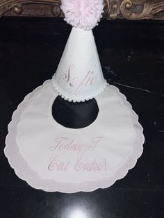 "These Fancy Bibs for baby boy or girl are perfect when dressing up for a birthday party!  The Scalloped Edge Cotton Fancy Bib has white fabric for the top and pink bottom layer, Velcro closure. This bib measures approximately 9\" wide x 9\" long and has a neck opening of approximately 3.75\" wide x 4\"  Embroidered in pink \"Today I Eat Cake!\" white Swiss dot hat with name embroidered in pink" Cute White Hat For First Birthday, Cute White Hat For Birthday, Cute White Party Supplies For Gifts, Cute White Party Supplies For Gift, Playful White Hat For First Birthday, Playful White Hats For Birthday, Playful White Hat For Birthday, Playful White Birthday Hat, Fun White Birthday Hat