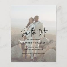 the save the date photo card is shown on a marble surface with rocks in the background