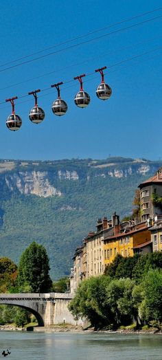 the cable cars are going over the river