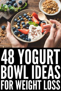 a bowl filled with fruit and yogurt on top of a wooden table next to bowls