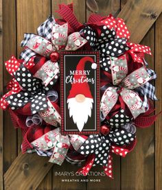 a christmas wreath with a santa clause on it and polka dot ribbon around the front