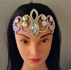 a woman wearing a tiara made out of jewels and other jeweled items on her head