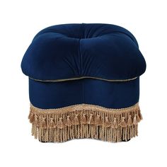 a blue ottoman with tassels on it