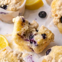 muffins with blueberries and lemon are on the table