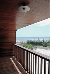 an empty balcony overlooking the beach and ocean