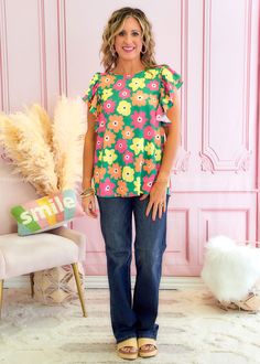 IN A GARDEN STATE OF MIND! Green w/ Pink, Orange & Yellow Florals Boat Neckline | Short Ruffled Sleeves | Curved Hemline Woven | No Stretch | Relaxed Fit Main: 100% Polyester Measurements Bust Measured Laid Flat Across Front | Armpit to Armpit S 20” | M 21” | L 22” | 1XL 23” | 2XL 24” | 3XL 25” Length Measured Shoulder to Hemline S 27” | M 27” | L 28” | 1XL 28” | 2XL 29” | 3XL 30” Model: Holly is wearing a Small Brand: First Love Green Vibrant Print Summer Blouse, Summer Green Blouse With Vibrant Print, Summer Blouse With Vibrant Green Print, Summer Green Floral Print Blouse, Green Floral Print Summer Blouse, Spring Green Floral Print Blouse, Spring Floral Print Green Blouse, Green Floral Print Blouse For Spring, Trendy Green Blouse With Vibrant Print