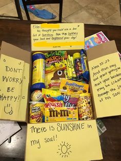 an open box filled with candy and some writing on the inside, sitting on top of a table