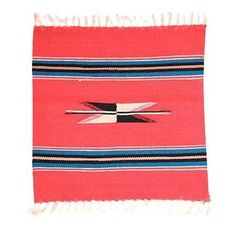 a red and black striped rug with fringes