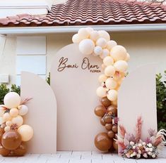 an arch made out of balloons and flowers