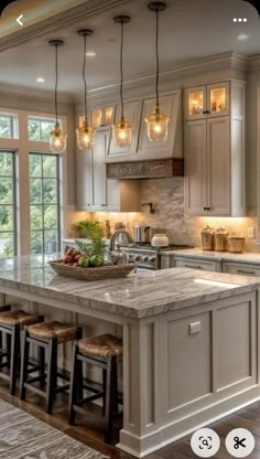 a large kitchen with an island in the middle and lots of stools around it