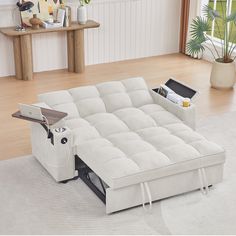 a white couch sitting on top of a hard wood floor