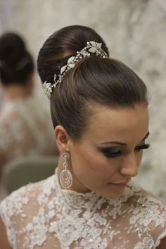 a woman in a wedding dress wearing a tiara